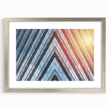 Abstract art print of skyscrapers in silver frame, featuring cool gray and blue tones, ideal for modern dining room decor.