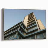Vintage poster art of a skyscraper, framed canvas with silver edges, featuring a monochrome palette.