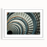 Abstract art print of a spiral staircase in black and white, framed in white, suitable for bedroom or dining room decor.