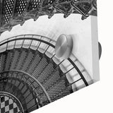 Close-up of a large abstract wall art on acrylic glass featuring spiral staircase design in monochrome shades.