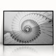 Large abstract wall art depicting a spiral staircase in black and white, framed in acrylic, suitable for modern decor.