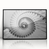 Large abstract wall art depicting a spiral staircase in black and white, framed in acrylic, suitable for modern decor.