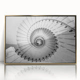 Mid-century modernist spiral staircase design in gold and black tones on a framed acrylic.