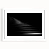 Abstract art print of a spiral staircase in monochrome, framed in white, suitable for dining room or bedroom decor.