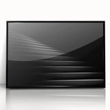 Large abstract wall art featuring a spiral staircase in monochrome, framed in black acrylic.