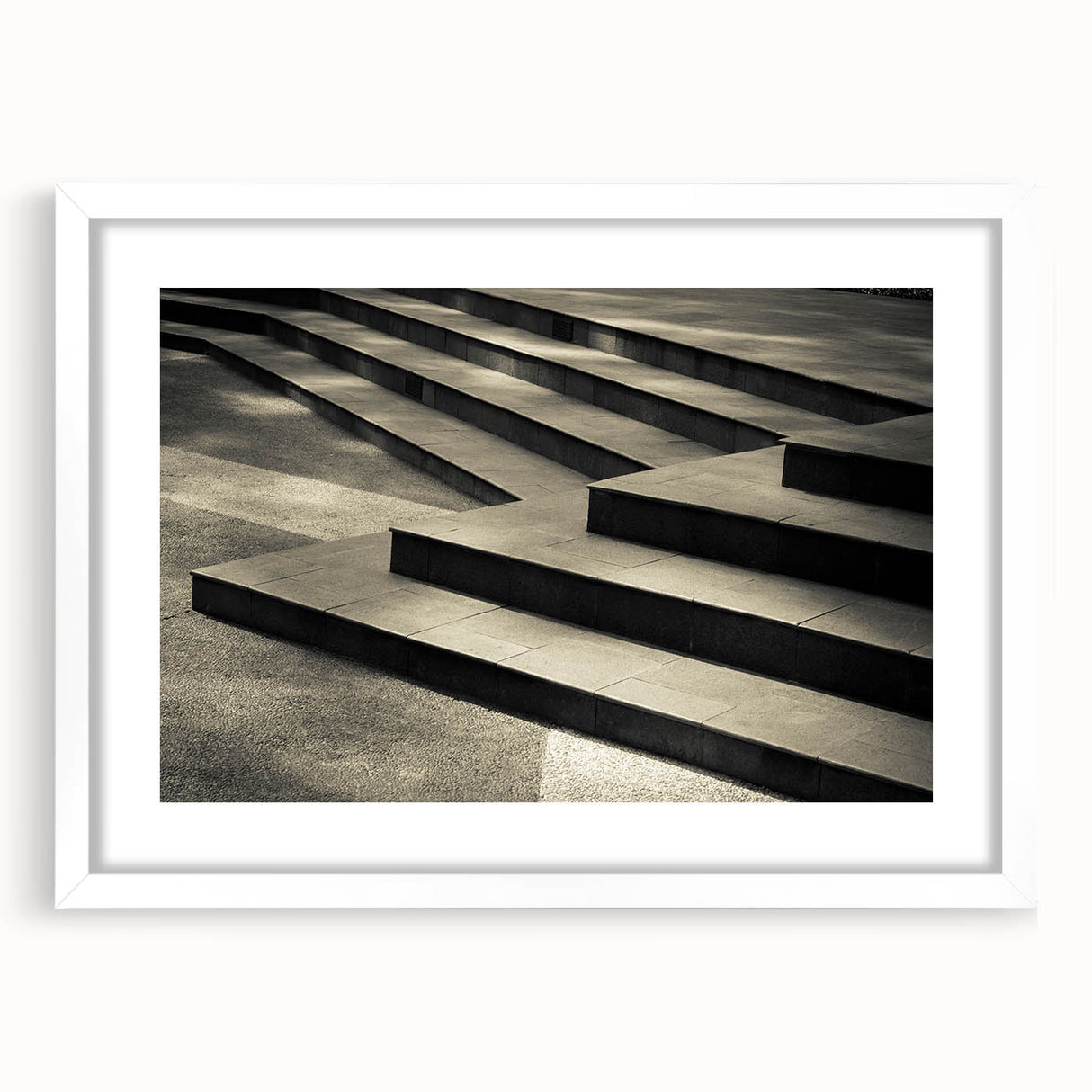 Abstract art print of a spiral staircase in monochrome, framed with a white mat, suitable for bedroom or dining room decor.