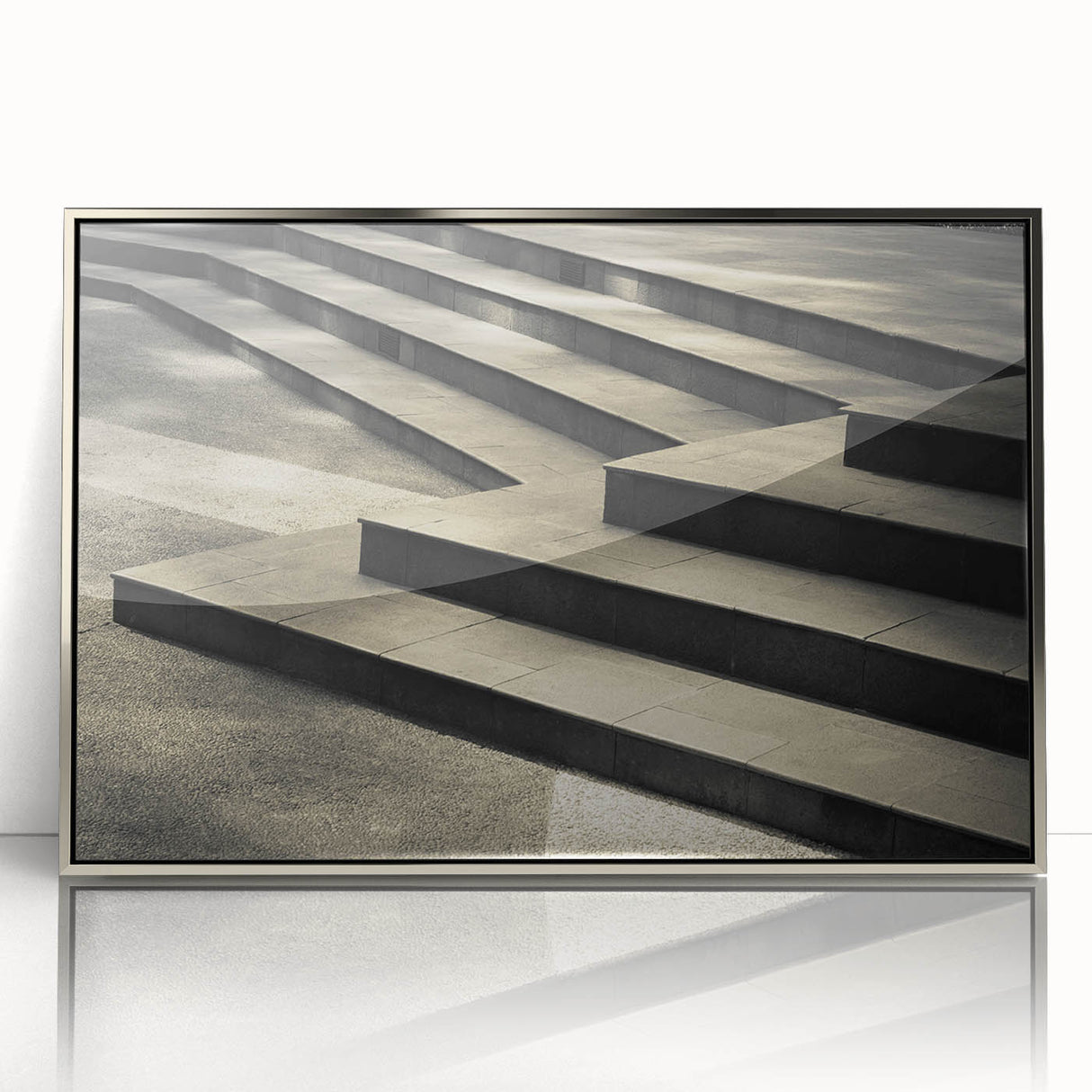 Mid-century modernist art of a spiral staircase in silver and gray tones on a framed acrylic.