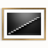 Extra large abstract art print of a spiral staircase in muted gray and gold tones, framed with a gold mat.