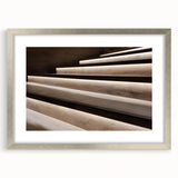 Textured abstract art print of a spiral staircase in muted gray tones on a framed canvas, suitable for bedroom decor.