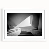 Abstract art print of a spiral staircase in black and white, framed with a white mat, ideal for bedroom or dining room decor.