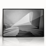 Large abstract wall art featuring a spiral staircase in black and white, acrylic print in a black frame.