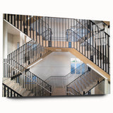 Side view of a large abstract acrylic print featuring a spiral staircase in grayscale tones.