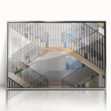 Mid-century modernist art featuring a spiral staircase in muted gray and blue tones, acrylic print framed in silver.