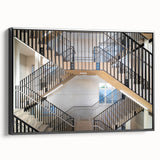 Black and white wall art featuring a vintage poster-style landscape of a spiral staircase on framed canvas.