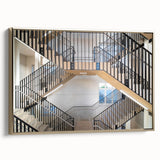 Framed canvas featuring a vintage poster of a black architectural staircase in gold tones, ideal for bedroom wall decor.