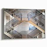 Framed canvas featuring a grayscale vintage poster of a spiral staircase, ideal for adding a classic touch to office spaces.