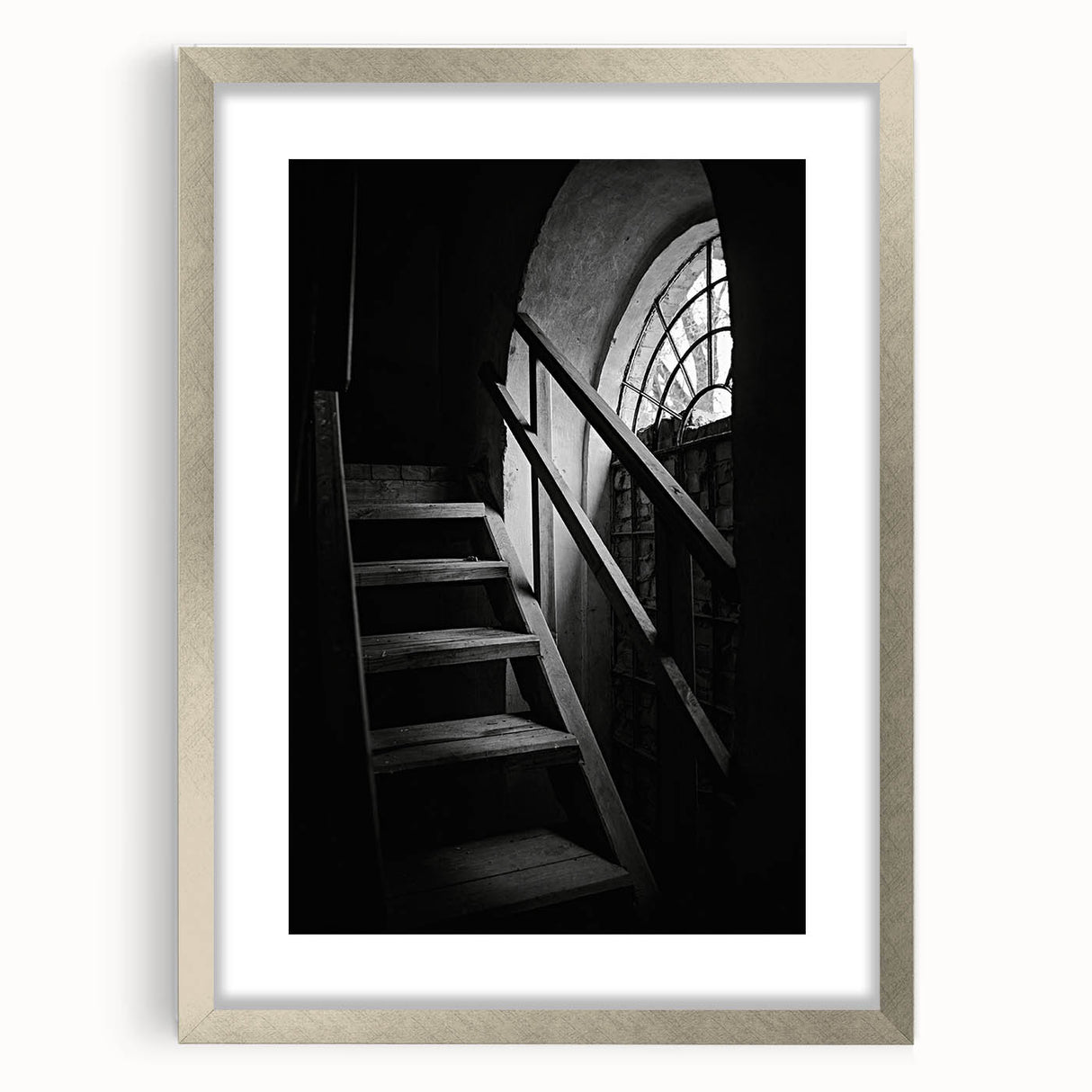 Abstract textured art print of a spiral staircase in muted gray tones, displayed in a silver frame.