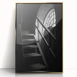 Mid-century modernist spiral staircase in black and gold tones on a framed acrylic, ideal for modern art wall decor.