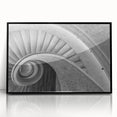 Large abstract wall art featuring a spiral staircase design in black and white, presented in a framed acrylic.