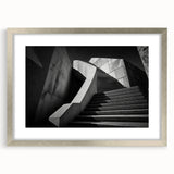 Textured art of an abstract staircase in muted gray tones on a framed silver mat, ideal for modern bedroom decor.