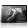 Large abstract wall art featuring a spiral staircase in black and white tones, framed in acrylic.