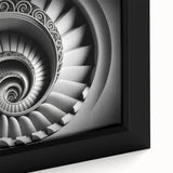 Close-up of a black wall art featuring a spiral staircase design on a framed canvas, textured with vibrant color accents.