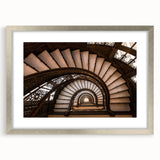 Textured art print of an abstract staircase in gray tones, framed in silver, ideal for modern bedroom decor.