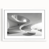 Abstract art print of a spiral staircase in monochrome, framed in white, suitable for dining room or bedroom decor.