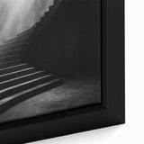 Close-up of a black wall art featuring a spiral staircase design in vibrant colors on a framed canvas.