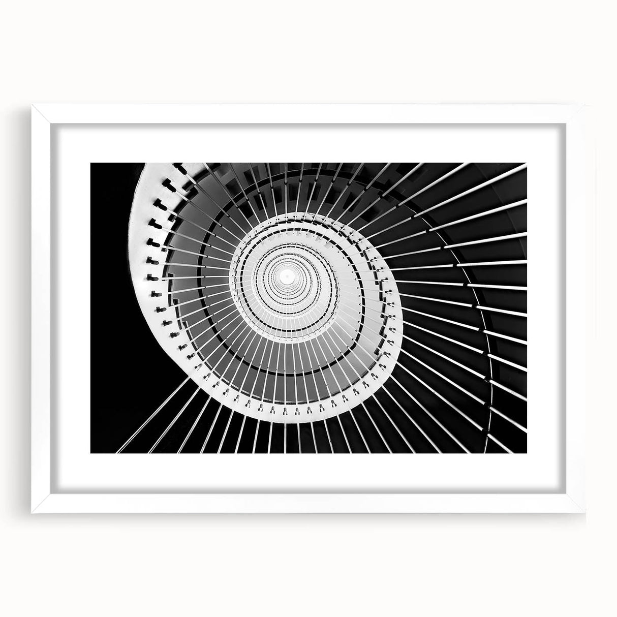 Abstract art print of a spiraling staircase in monochrome, framed in white, suitable for dining room or bedroom decor.