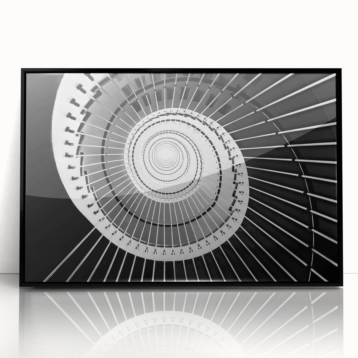Large abstract wall art featuring a spiral staircase in black and white, acrylic print in a black frame.