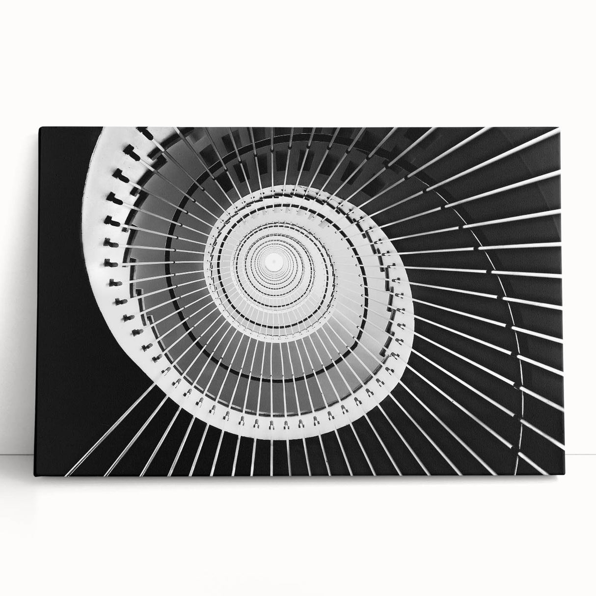 Black and white photograph of a spiral staircase on stretched canvas, ideal for kitchen wall art or bedroom ambiance.