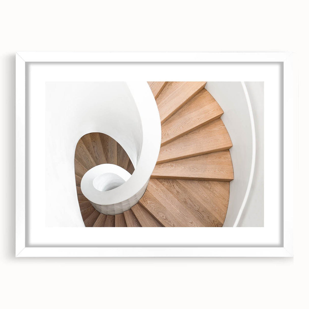 Abstract art print of a spiraling staircase in monochrome, framed with a white mat.