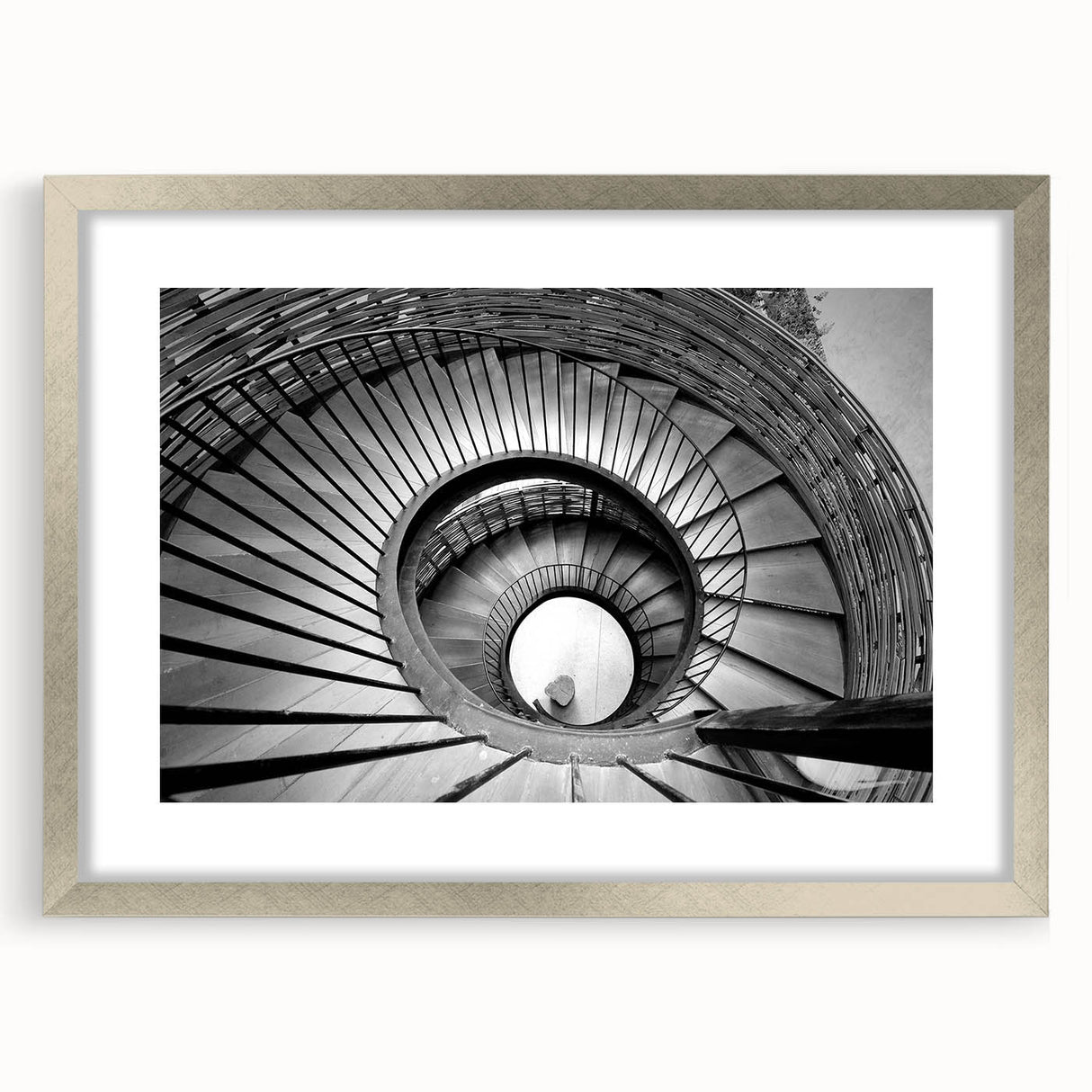 Textured abstract art print of a spiraling staircase in muted gray, framed in silver, ideal for bedroom art.