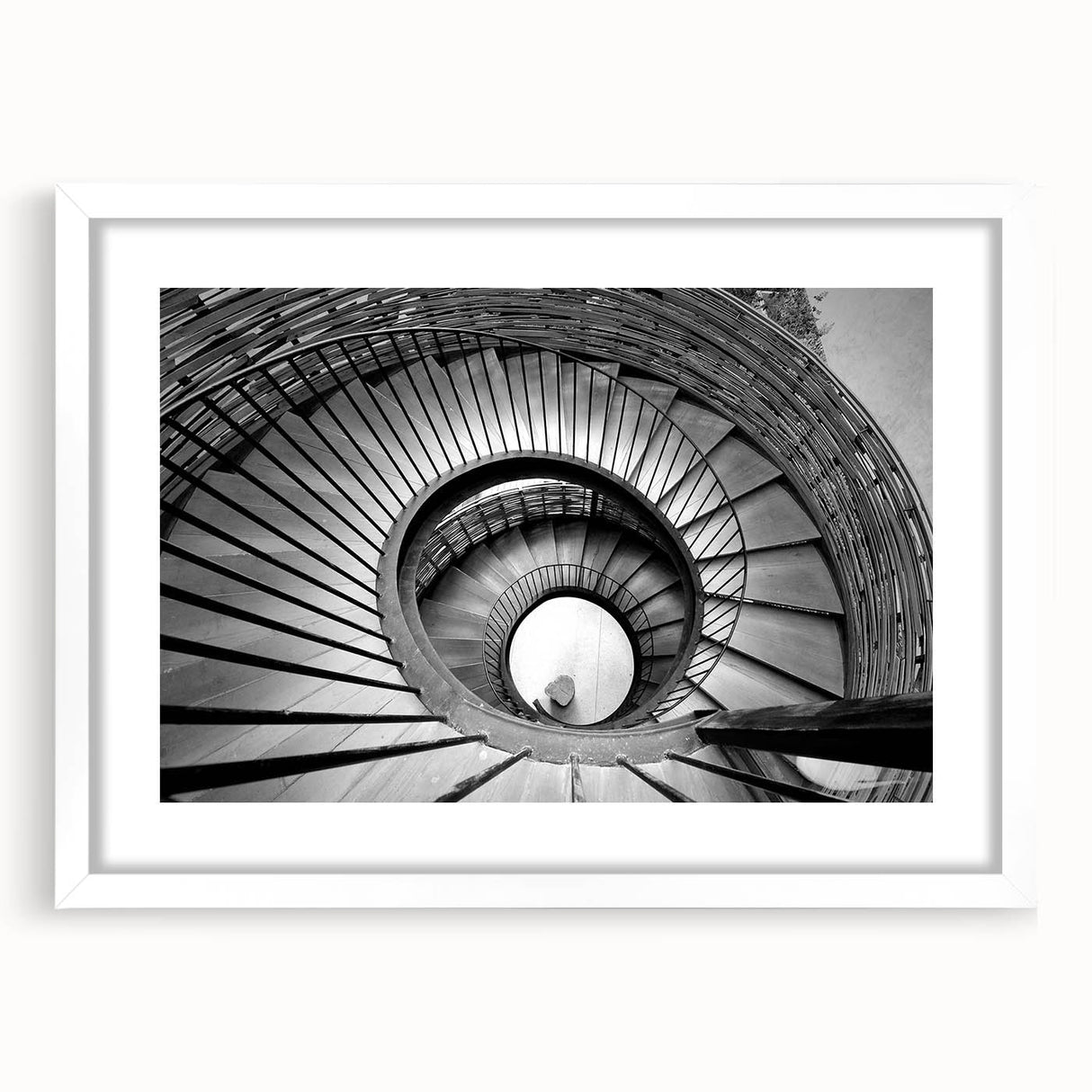 Abstract art print of a spiral staircase in monochrome, framed in white, ideal for modern dining room decor.