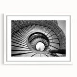 Abstract art print of a spiral staircase in monochrome, framed in white, ideal for modern dining room decor.