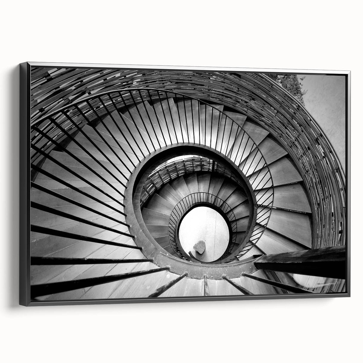 Black and white framed canvas of a spiraling staircase, ideal for bedroom wall decor.
