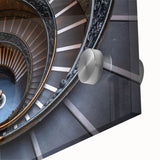 Close-up of a large abstract wall art print featuring swirling staircase design in monochrome, acrylic glass format.