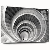 Large abstract wall art of a spiral staircase in muted gray tones on acrylic glass.
