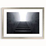 Textured art print of an abstract staircase in grayscale, framed in silver, ideal for modern bedroom decor.
