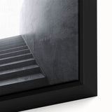 Close-up of a black wall art featuring a colorful, textured architectural staircase design on a framed canvas.