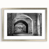 Abstract textured art print in silver frame, featuring intertwined gray and white tunnels, suitable for bedroom decor.