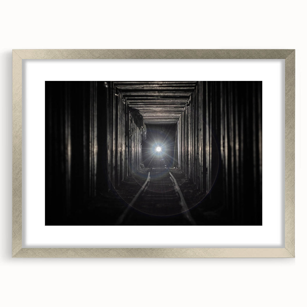 Textured abstract art print in muted gray and silver, framed with a mat, ideal for modern bedroom ambiance.