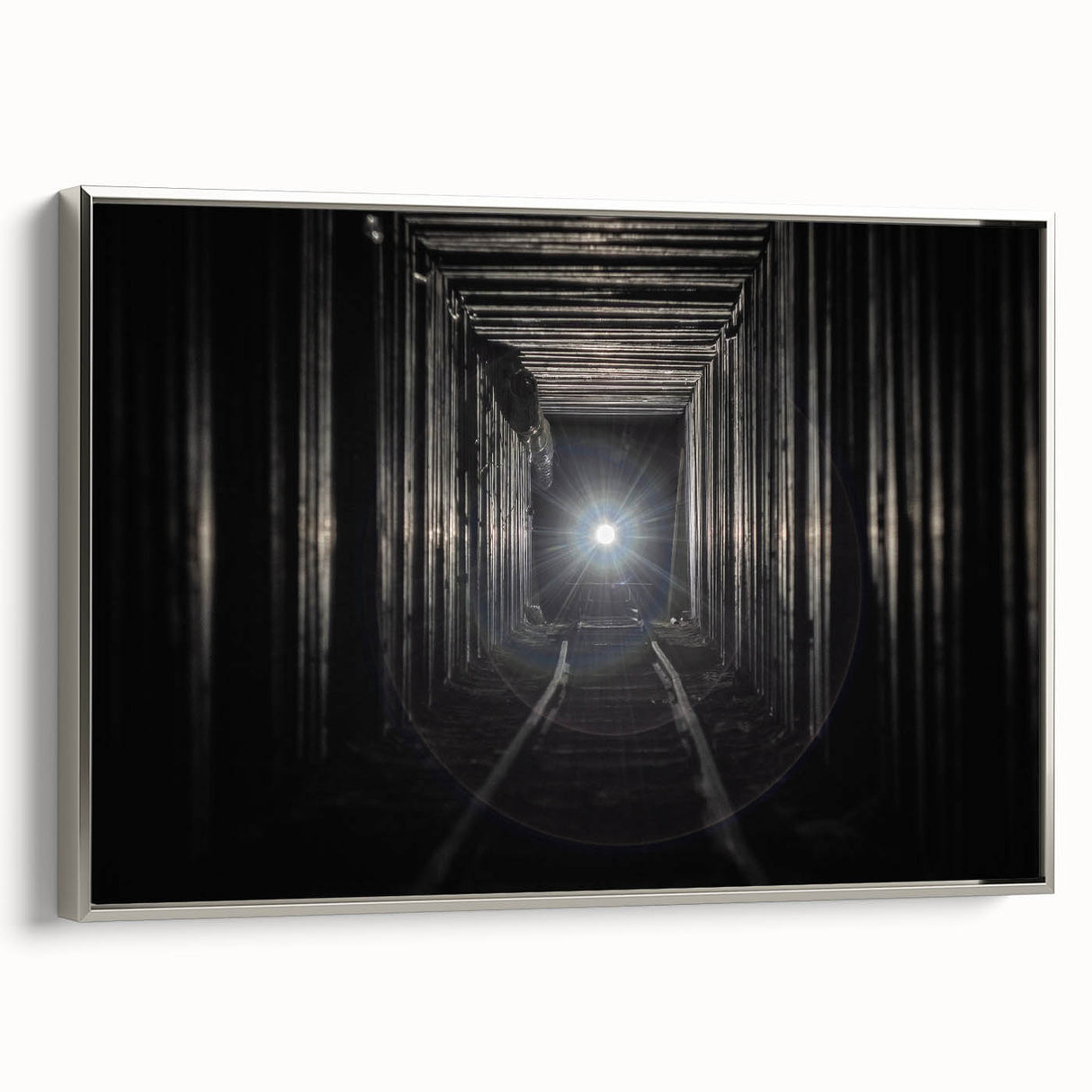 Framed canvas featuring a vintage poster of a colorful landscape with tunnels and arches in black and silver tones.