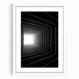 Abstract art print featuring swirling black and white patterns on a framed canvas, ideal for dining room decor.