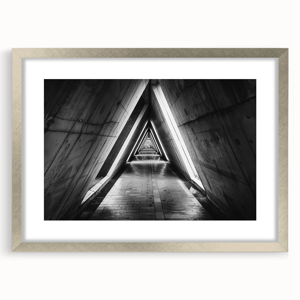 Textured art print of abstract geometric shapes in muted gray, framed in silver, ideal for bedroom art.