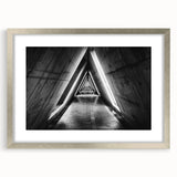 Textured art print of abstract geometric shapes in muted gray, framed in silver, ideal for bedroom art.