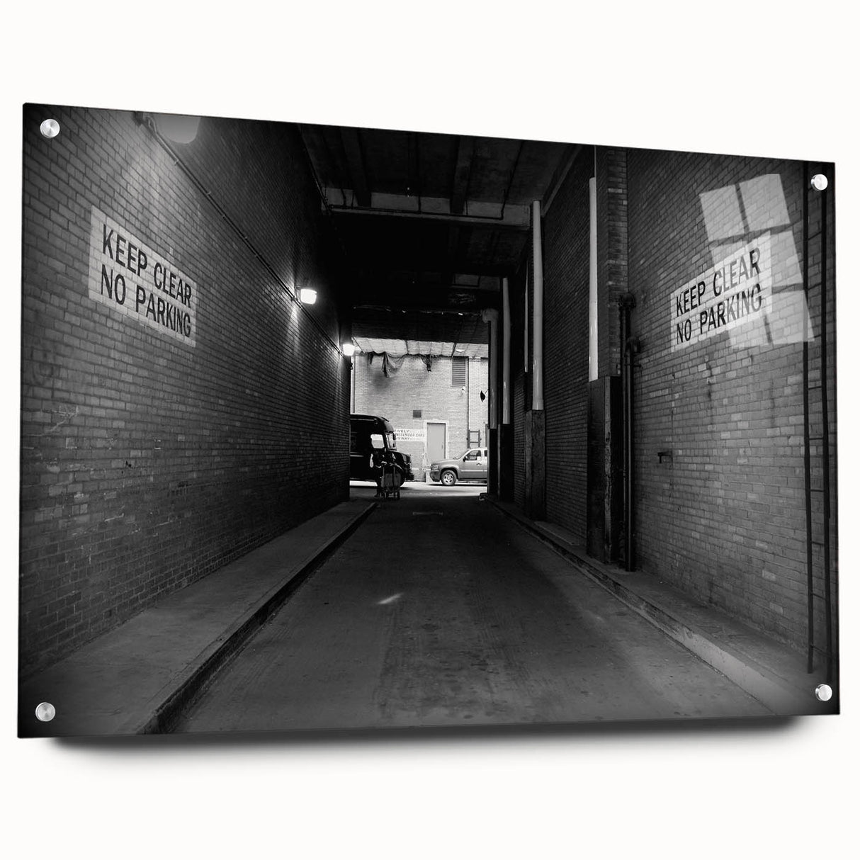 Large abstract wall art on acrylic glass depicting a monochrome architectural tunnel.