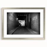 Textured abstract art print in silver frame, featuring a design resembling architectural tunnels, ideal for bedroom decor.