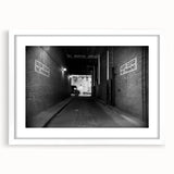 Abstract art print of intertwined tunnels in muted gray and white tones, framed with a white mat.